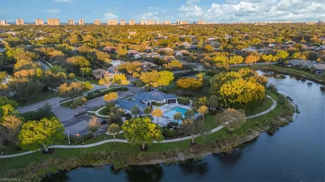 an aerial view of residential houses with outdoor space and trees