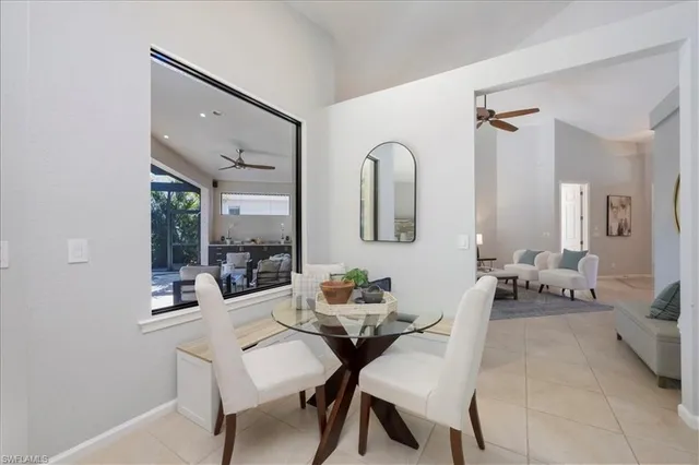 a dining room with furniture and a mirror