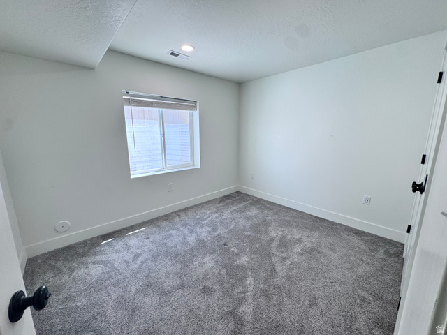 4729 Middleboro Road Herriman, UT 84096 - Photo 11 of 19 Room featuring plush gray carpeting, white walls, and a recessed ceiling light