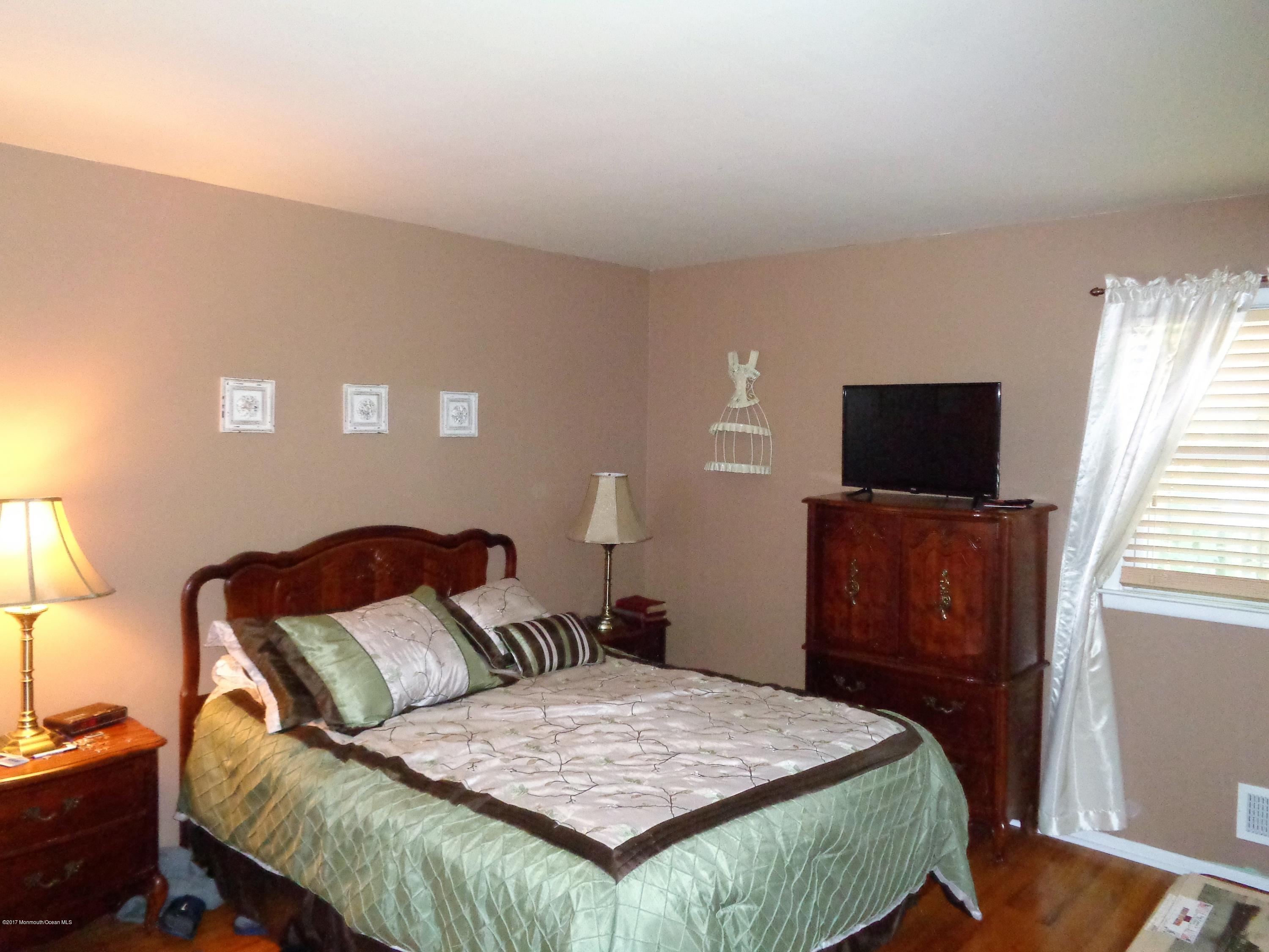 25 Pepperridge Road Howell, NJ 07731 - Photo 11 of 28 a bedroom with a bed and wooden floor