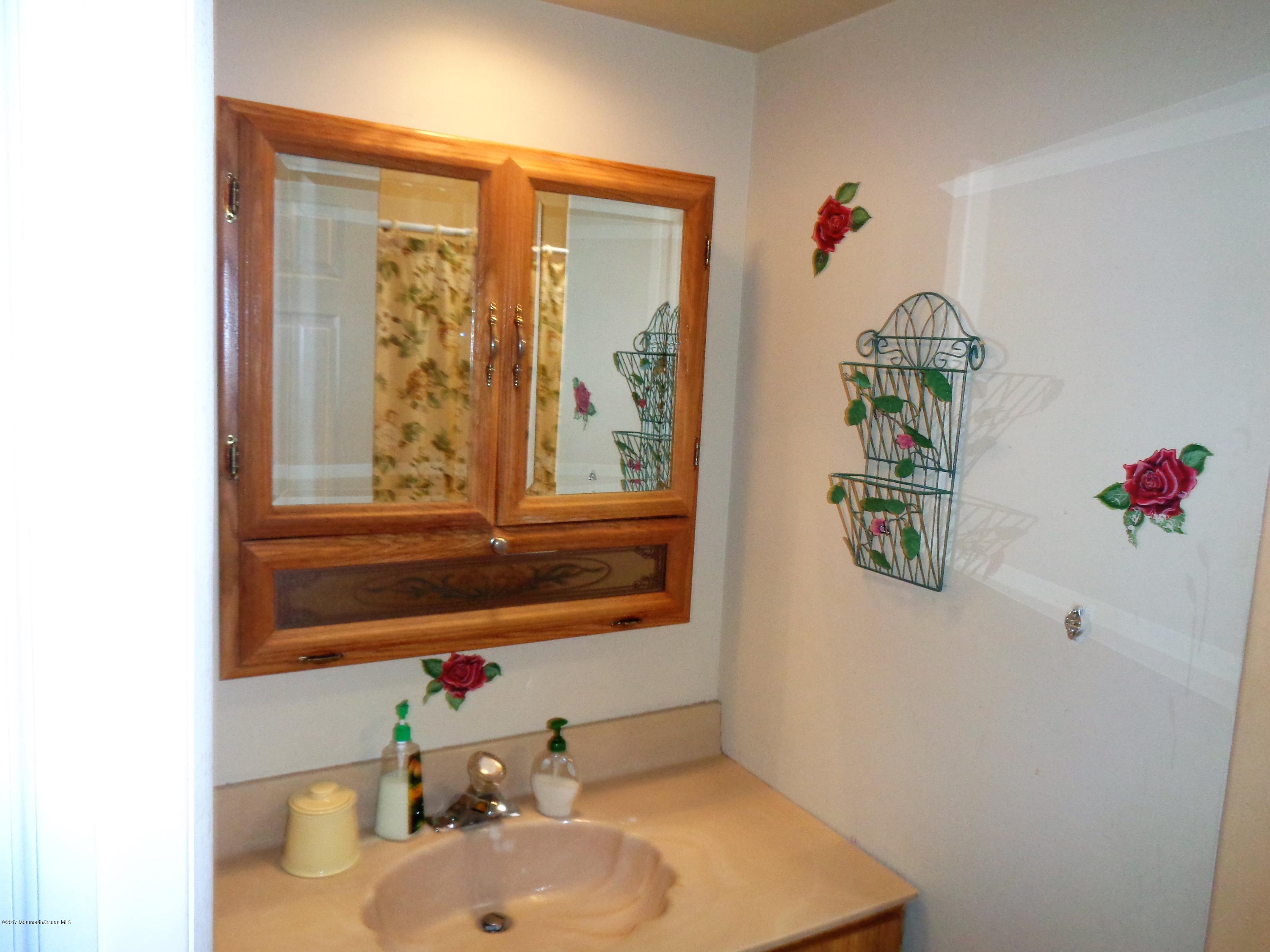 25 Pepperridge Road Howell, NJ 07731 - Photo 15 of 28 a bathroom with a sink and a mirror