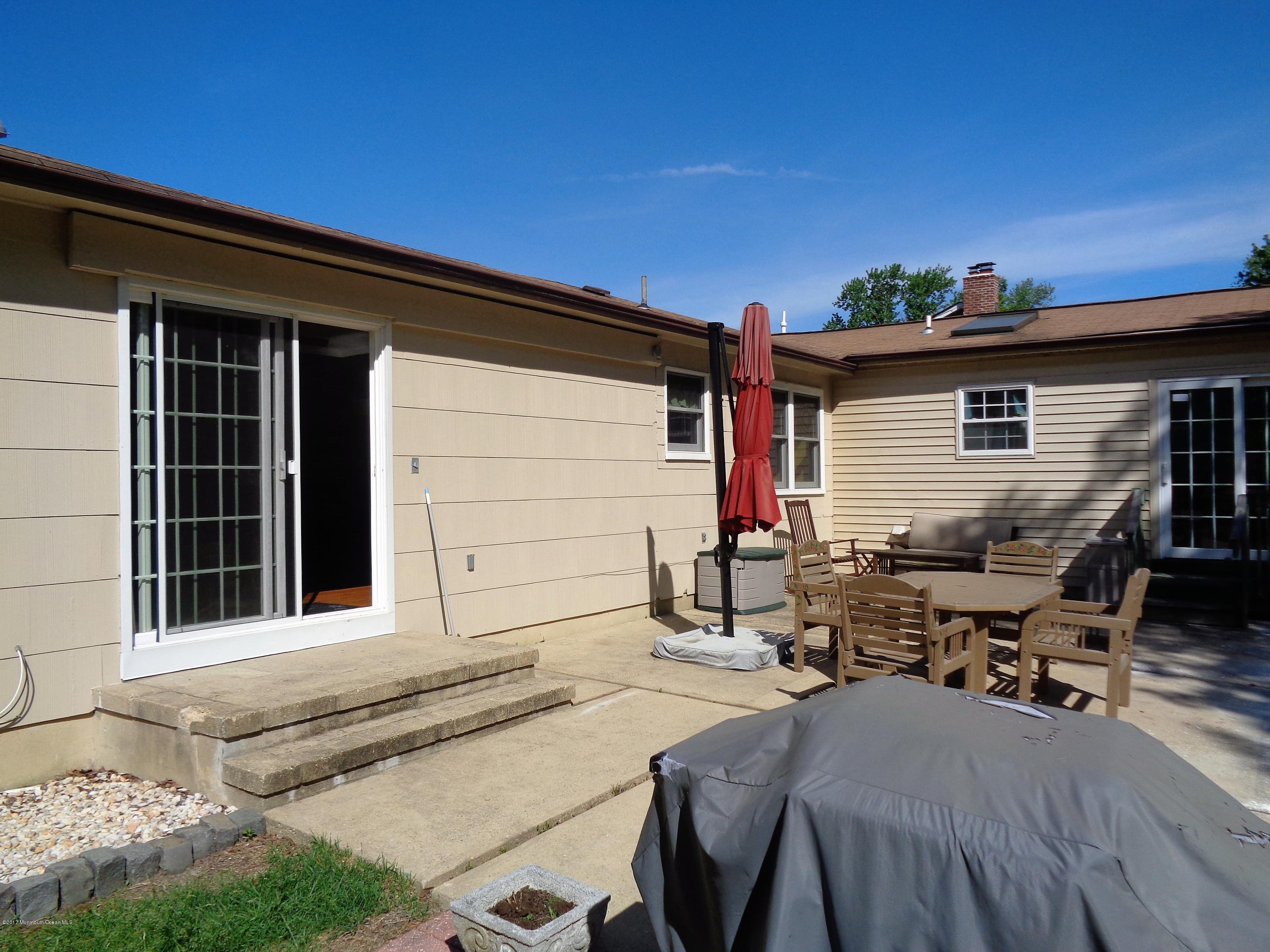 25 Pepperridge Road Howell, NJ 07731 - Photo 17 of 28 a backyard of a house with table and chairs