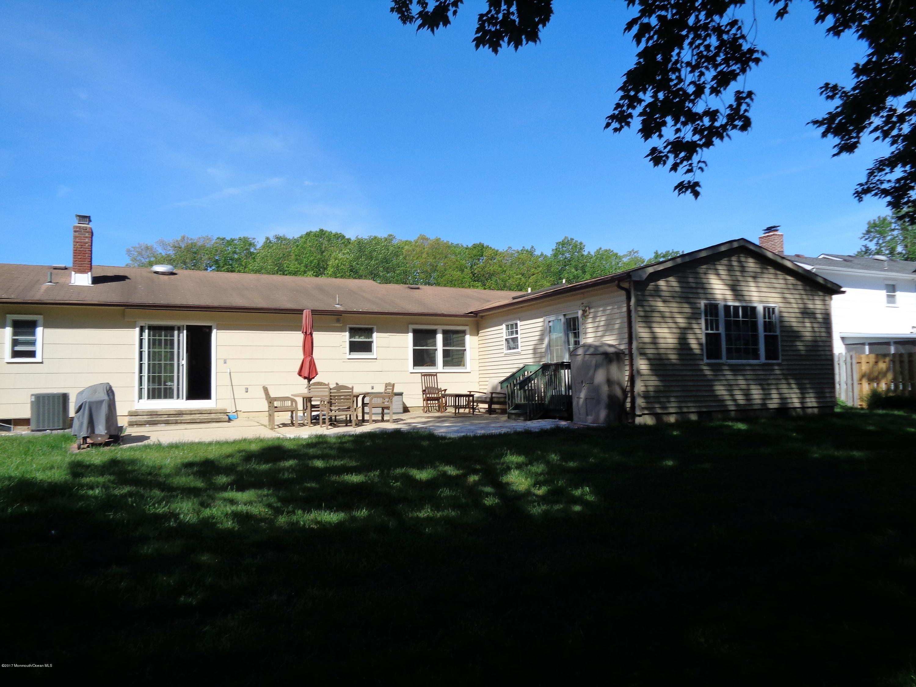 25 Pepperridge Road Howell, NJ 07731 - Photo 19 of 28 a front view of a house with a garden
