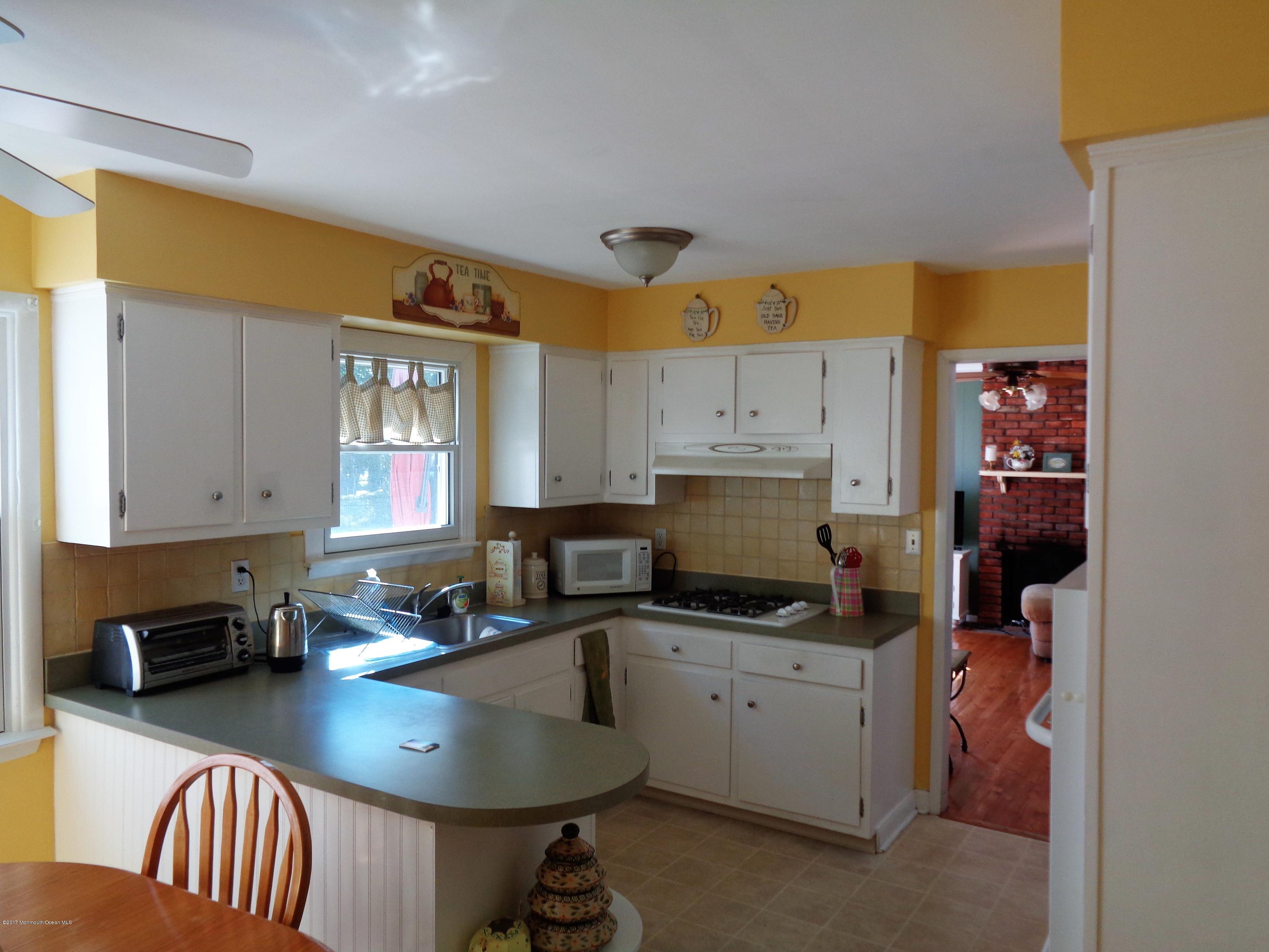 25 Pepperridge Road Howell, NJ 07731 - Photo 3 of 28 a kitchen with a sink a stove and cabinets