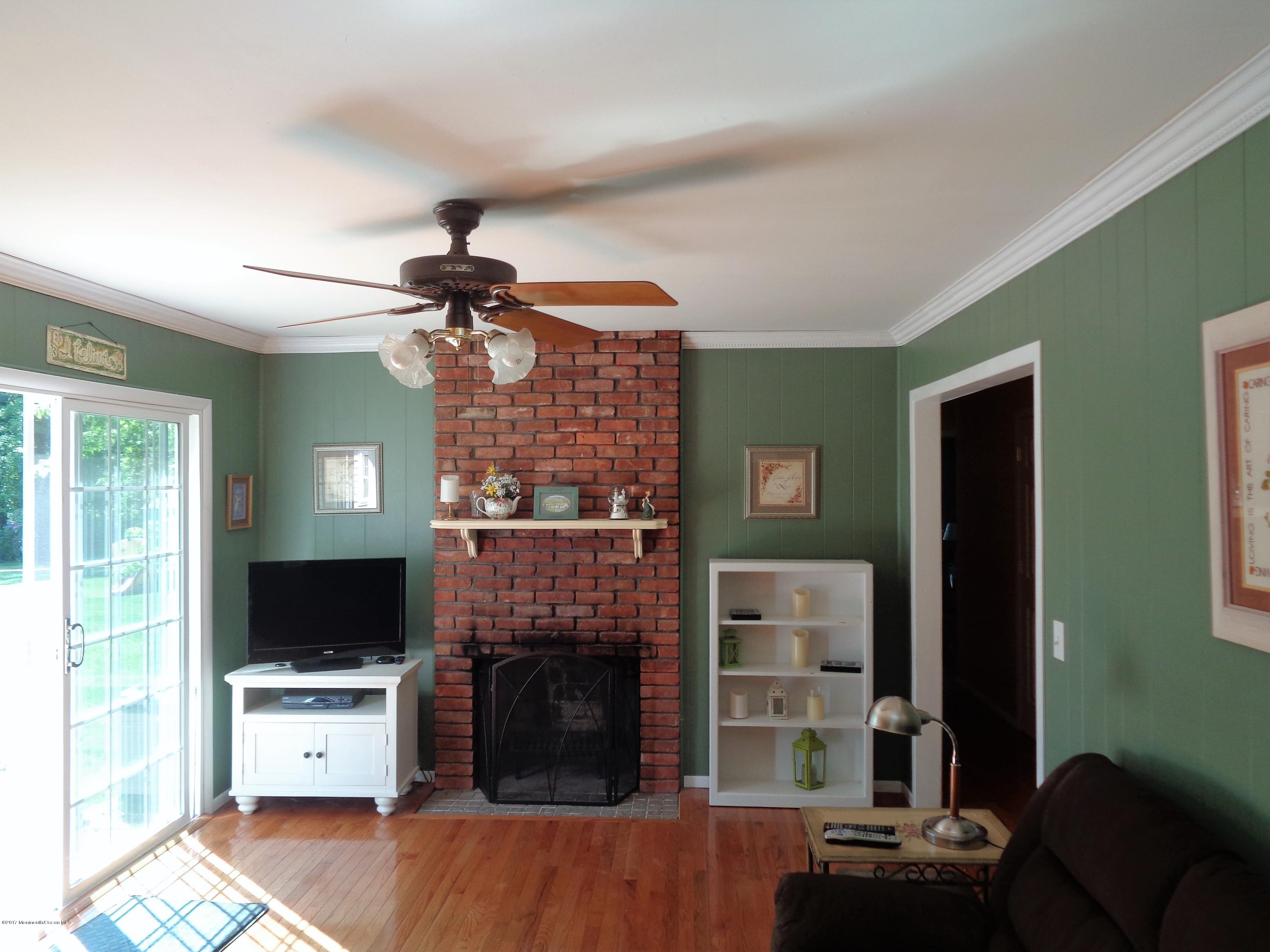25 Pepperridge Road Howell, NJ 07731 - Photo 9 of 28 a living room with furniture a flat screen tv and a fireplace