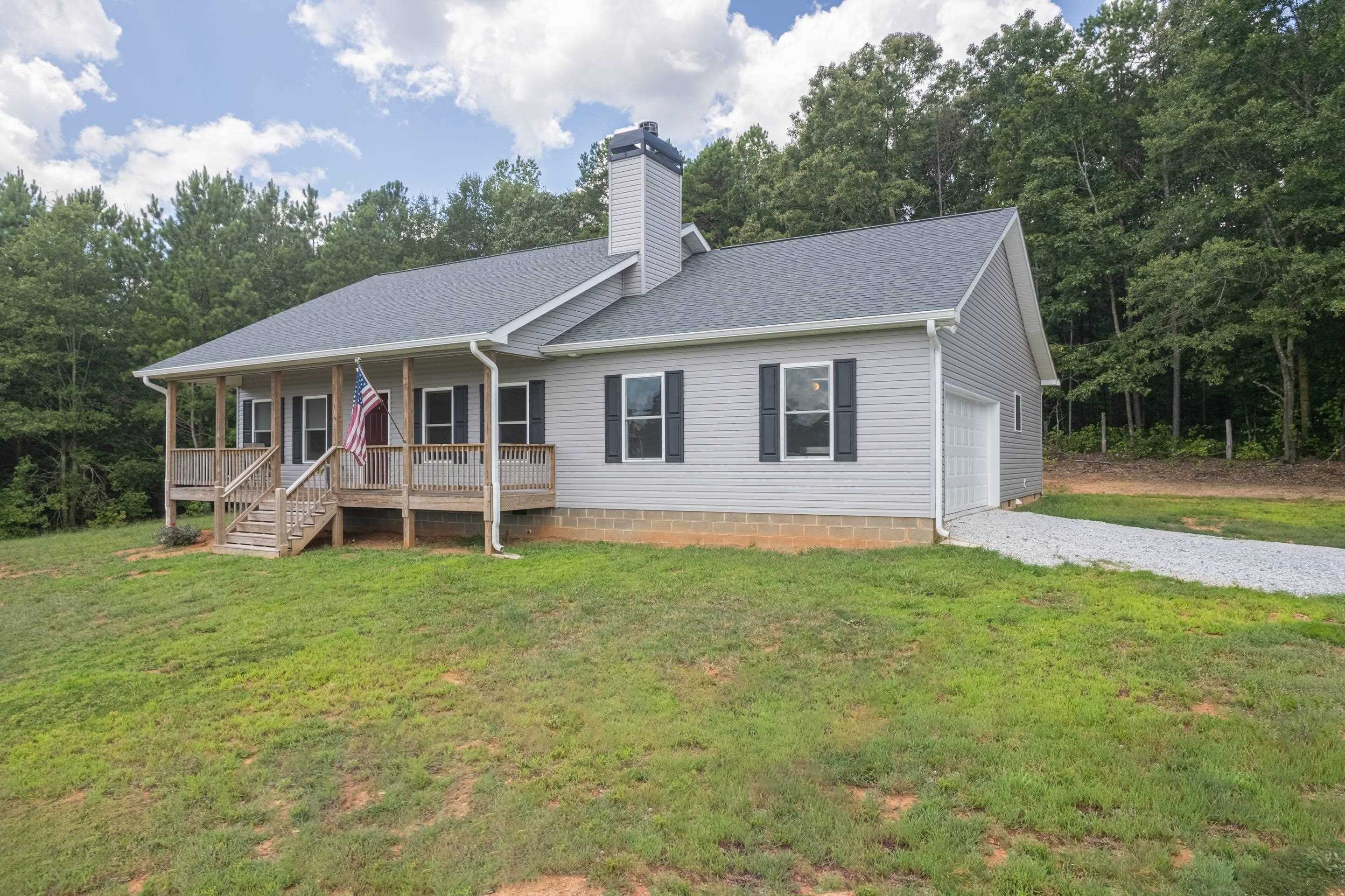 357 Reggie Ingram Road Commerce, GA 30530 - Photo 1 of 1 a house that has a lot of plants in it