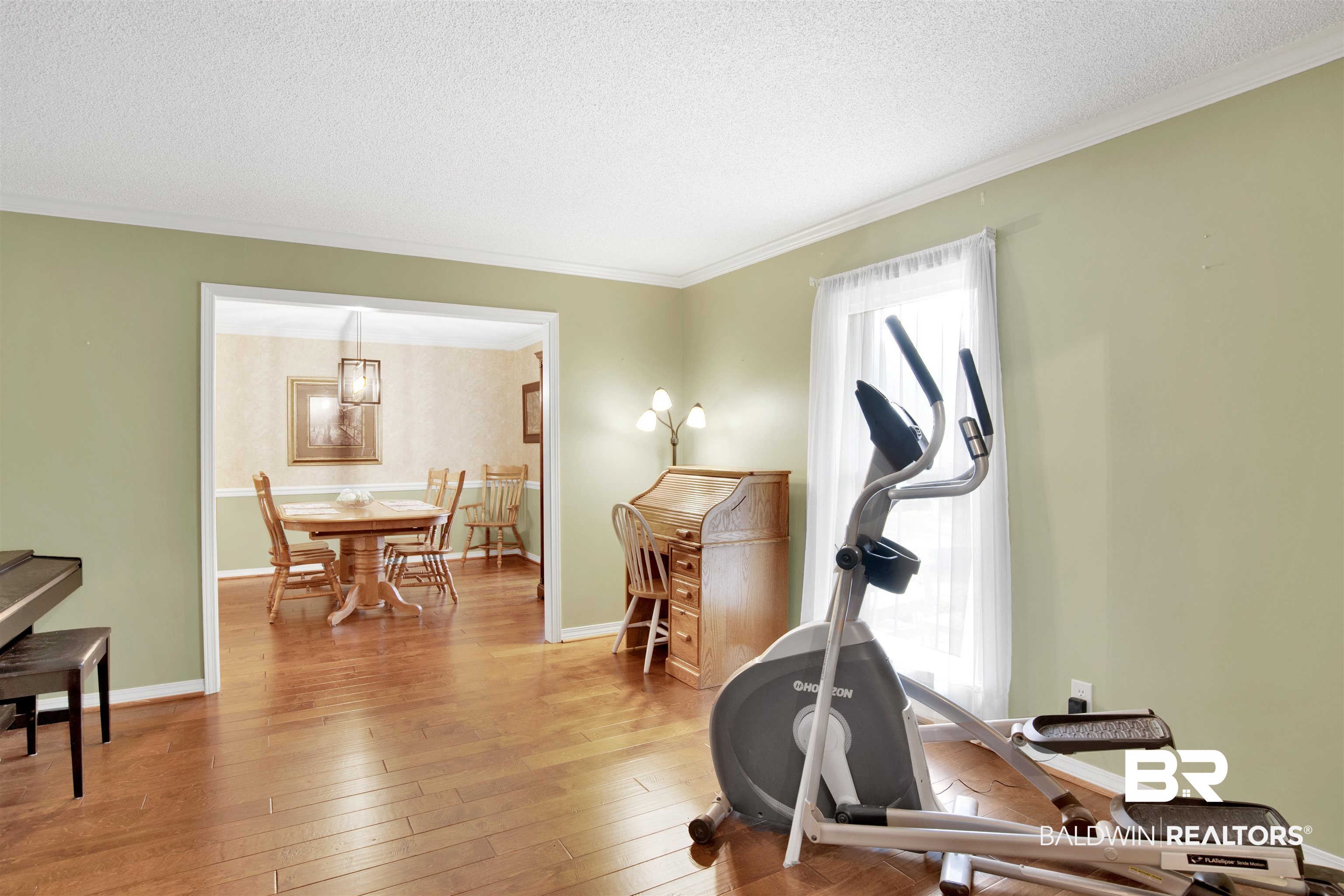 7431 Summer Court Mobile, AL 36695 - Photo 8 of 37 Exercise room featuring ornamental molding, light wood-style flooring, a textured ceiling, and baseboards