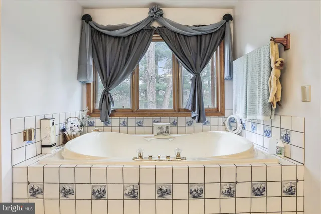 a living room with furniture a window and a wooden floor