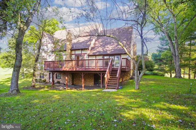 a living room with furniture a fireplace and a chandelier