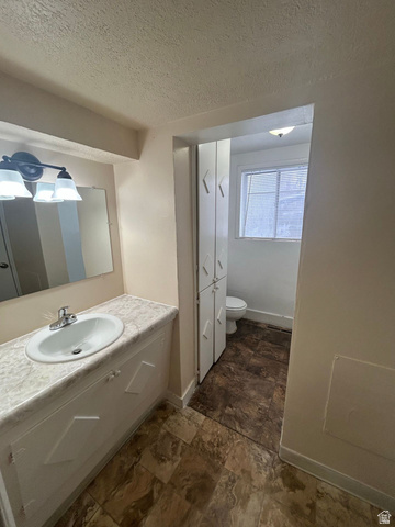 265 Rigdon Avenue, Unit 1 Salt Lake City, UT 84115 - Photo 12 of 15 Bathroom vanity featuring a single basin sink and laminate countertop