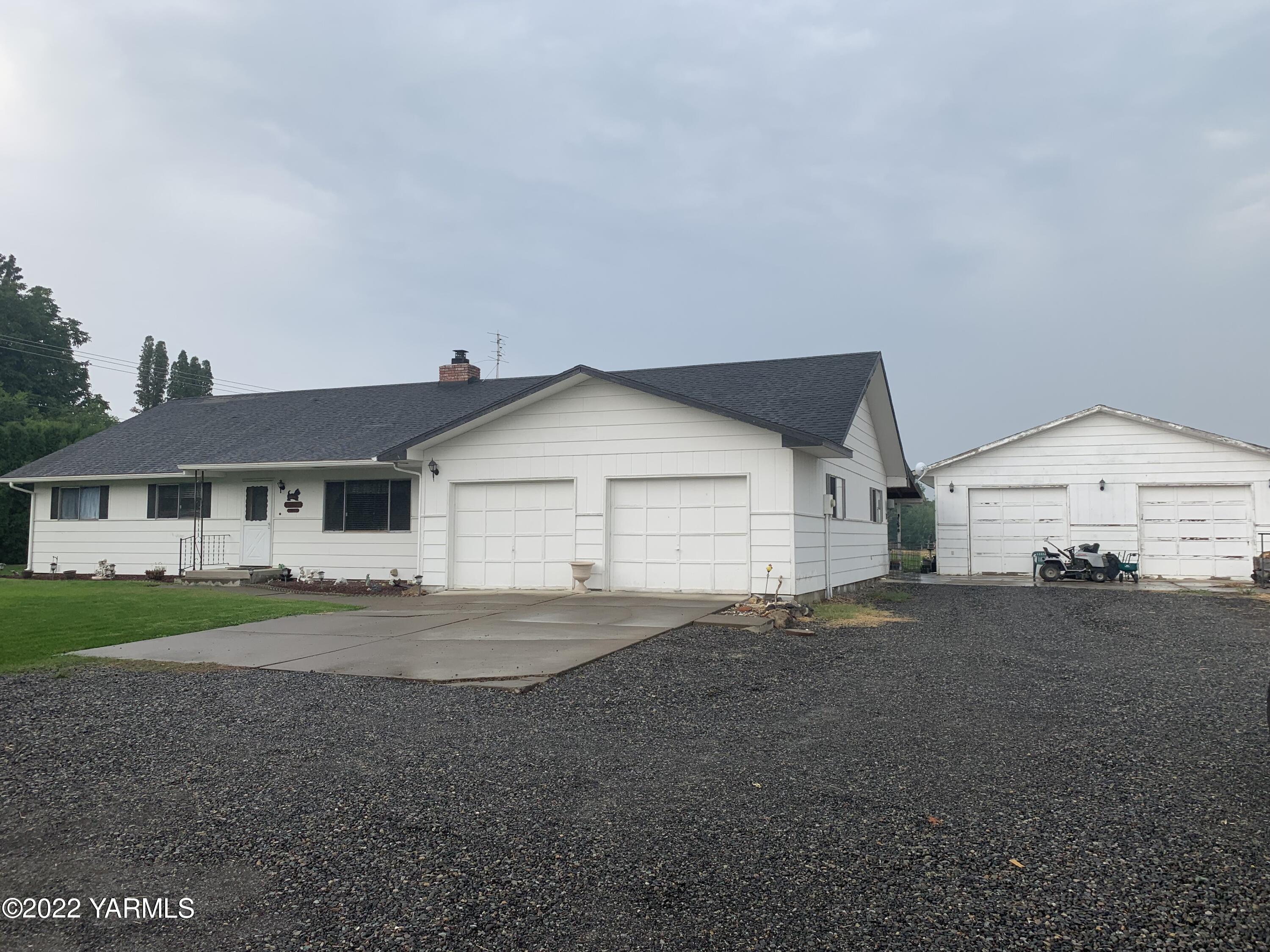 11105 Occidental Road Yakima, WA 98903 - Photo 1 of 30 a front view of a house with a yard and garage