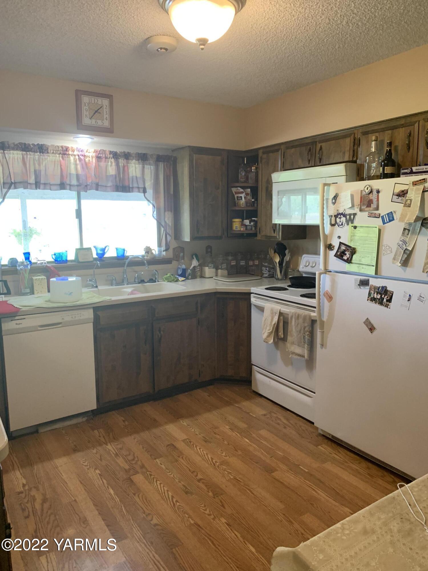 11105 Occidental Road Yakima, WA 98903 - Photo 16 of 30 a kitchen with a sink a stove and cabinets