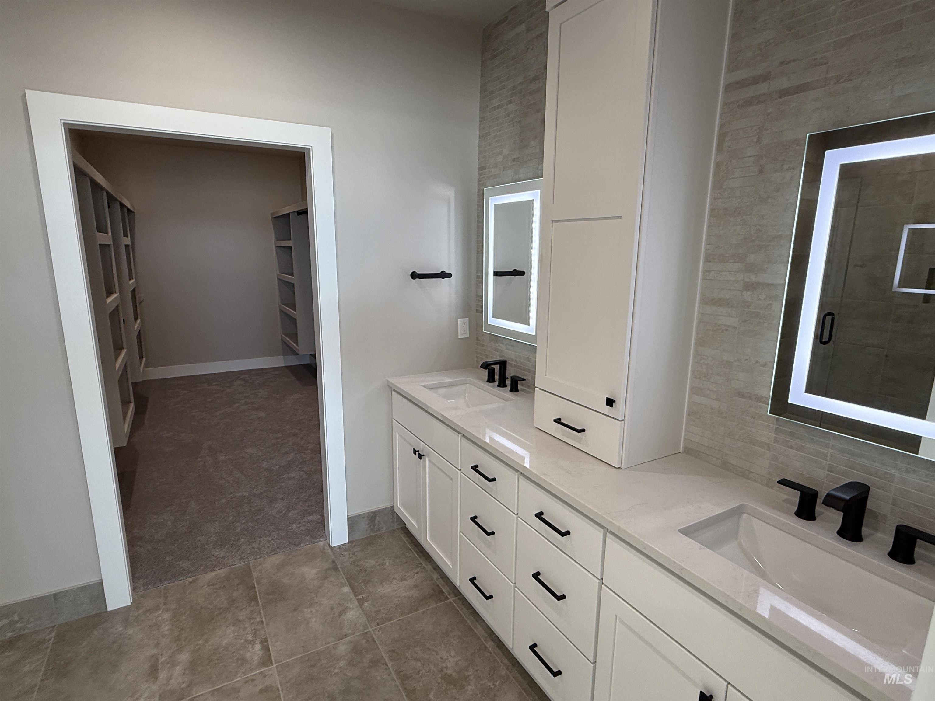14059 Mulberry McCall, ID 83638 - Photo 12 of 32 Full bathroom featuring double vanity, a spacious closet, light carpet, and light tile patterned flooring