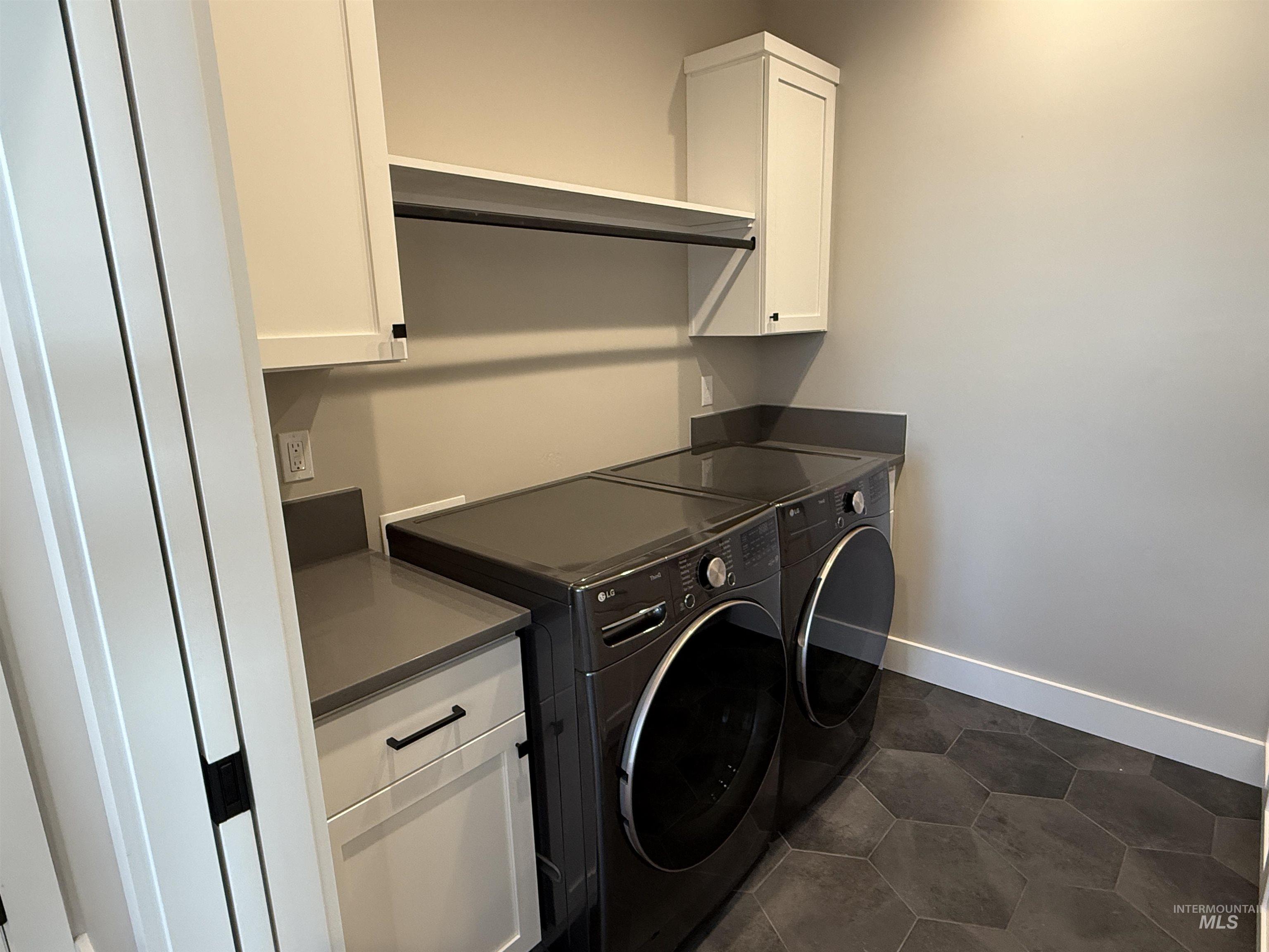 14059 Mulberry McCall, ID 83638 - Photo 18 of 32 Laundry area with washer and dryer and cabinet space