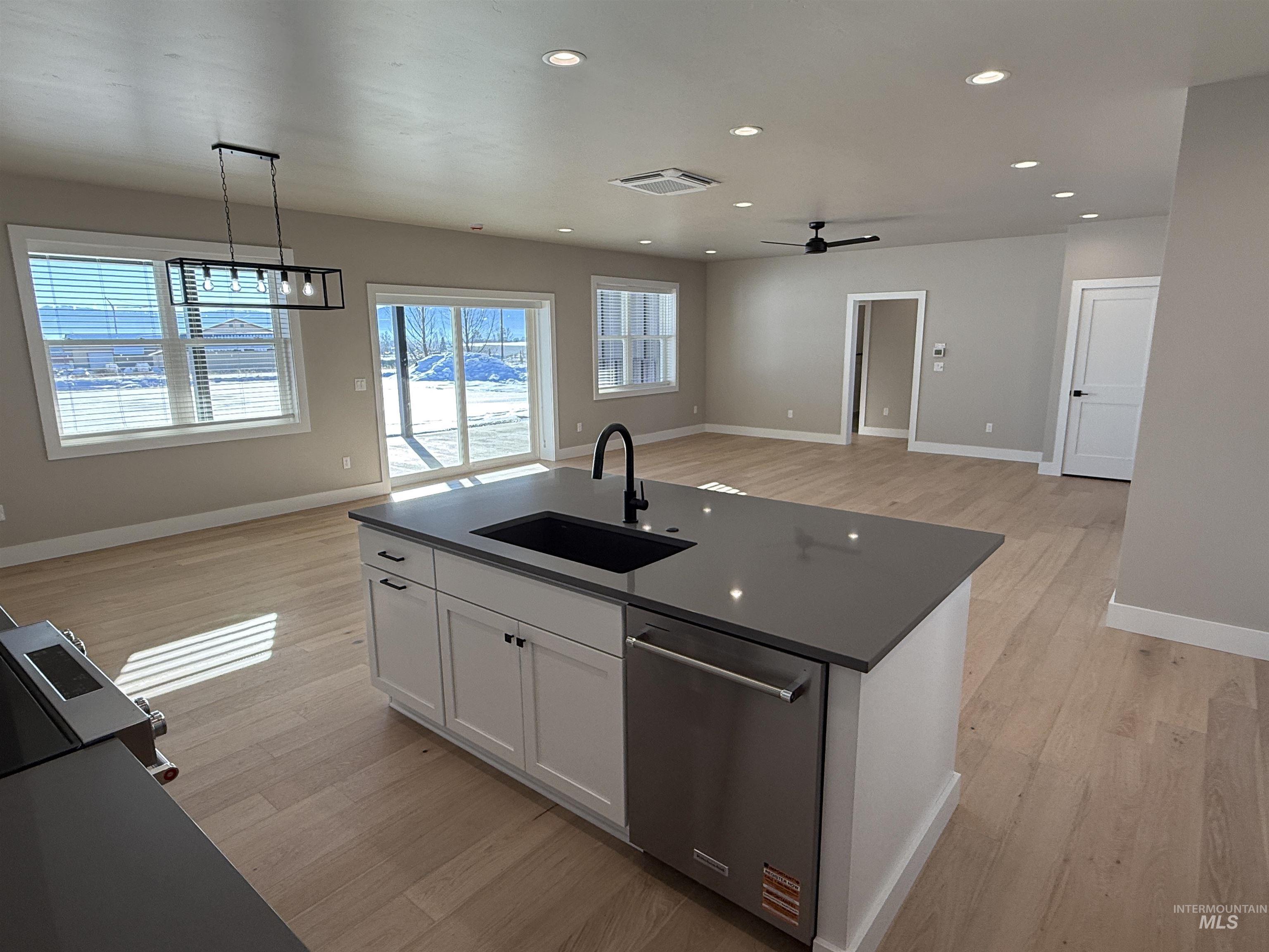 14059 Mulberry McCall, ID 83638 - Photo 32 of 32 Kitchen featuring open floor plan, recessed lighting, stainless steel appliances, pendant lighting, and white cabinetry