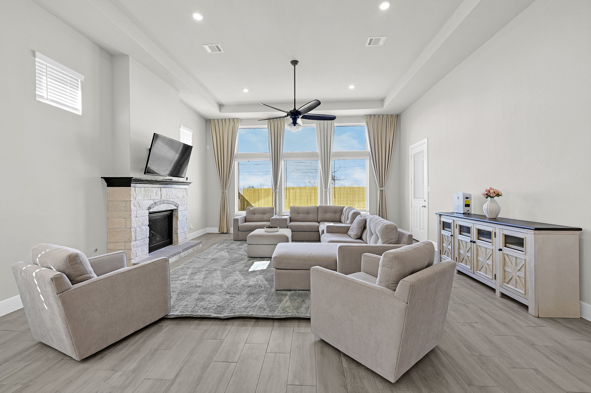 8 Palmero Way Manvel, TX 77578 - Photo 12 of 34 a living room with furniture a fireplace and a flat screen tv