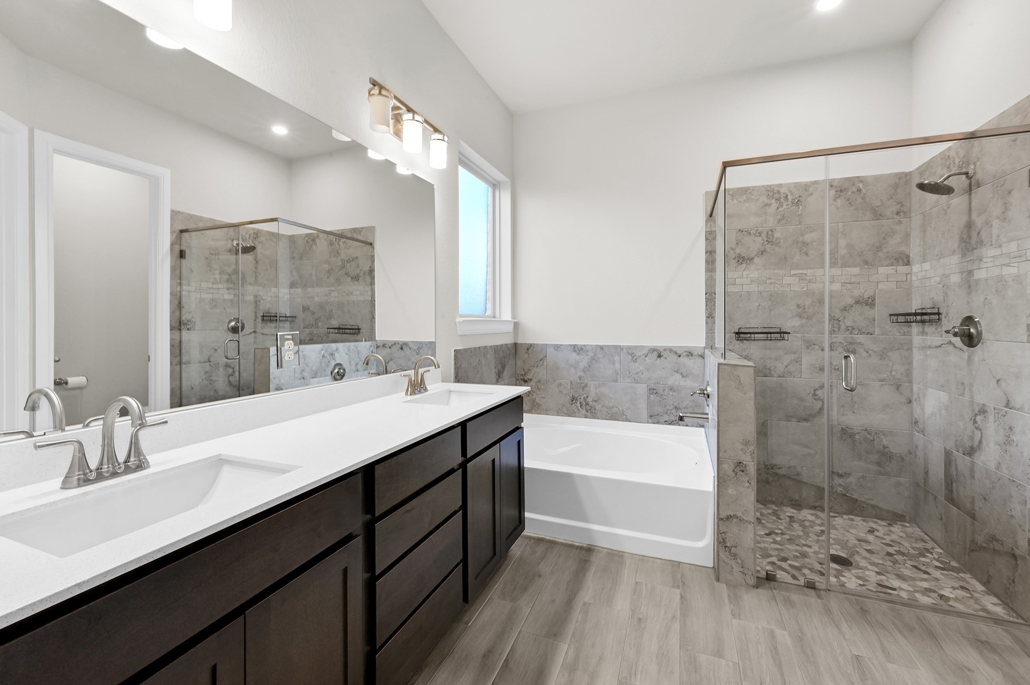 8 Palmero Way Manvel, TX 77578 - Photo 16 of 34 a bathroom with a double vanity sink a large mirror and shower