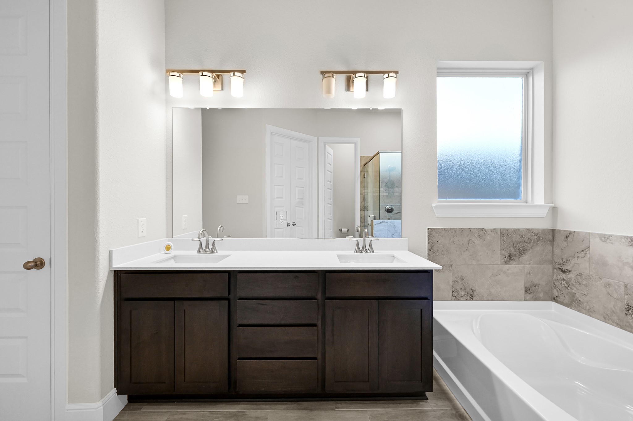8 Palmero Way Manvel, TX 77578 - Photo 17 of 34 a bathroom with a double vanity sink and a bathtub