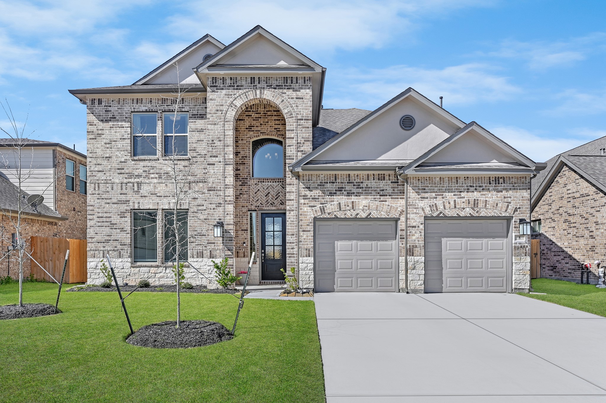 8 Palmero Way Manvel, TX 77578 - Photo 2 of 34 a front view of a house with a garden and plants