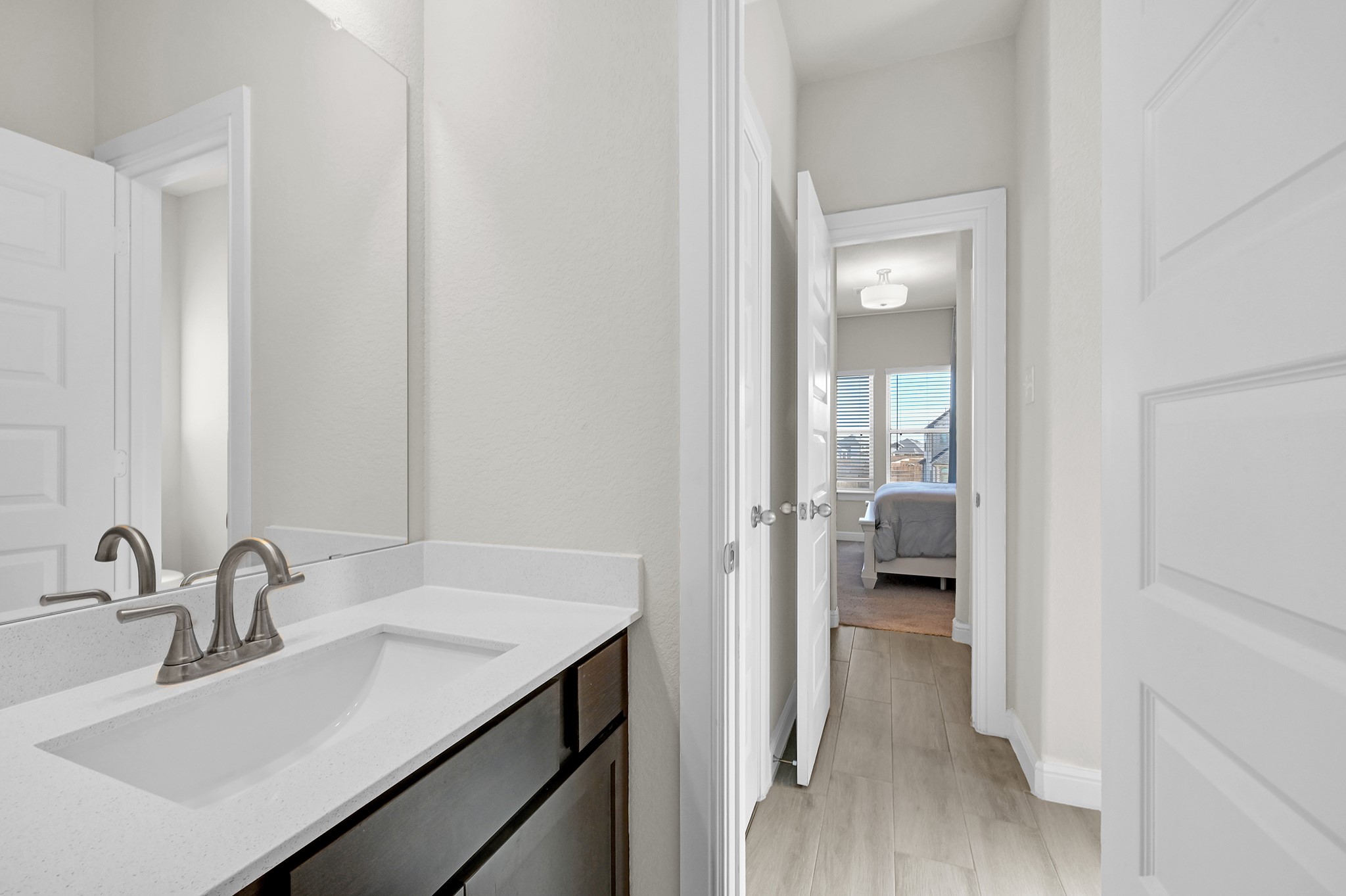 8 Palmero Way Manvel, TX 77578 - Photo 21 of 34 a en suite bathroom with a sink a mirror and a toilet