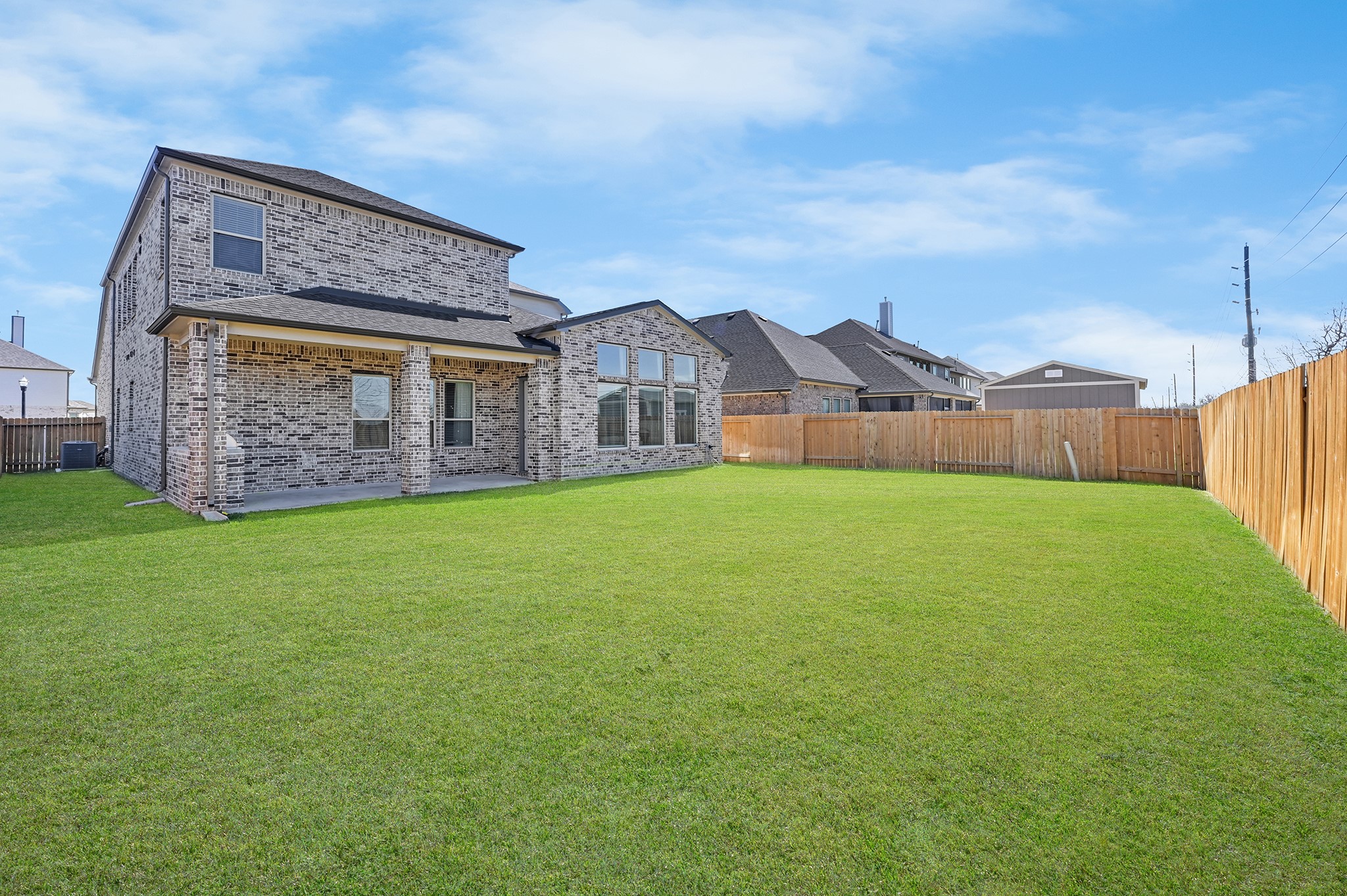 8 Palmero Way Manvel, TX 77578 - Photo 28 of 34 a view of a brick house with a big yard and large trees