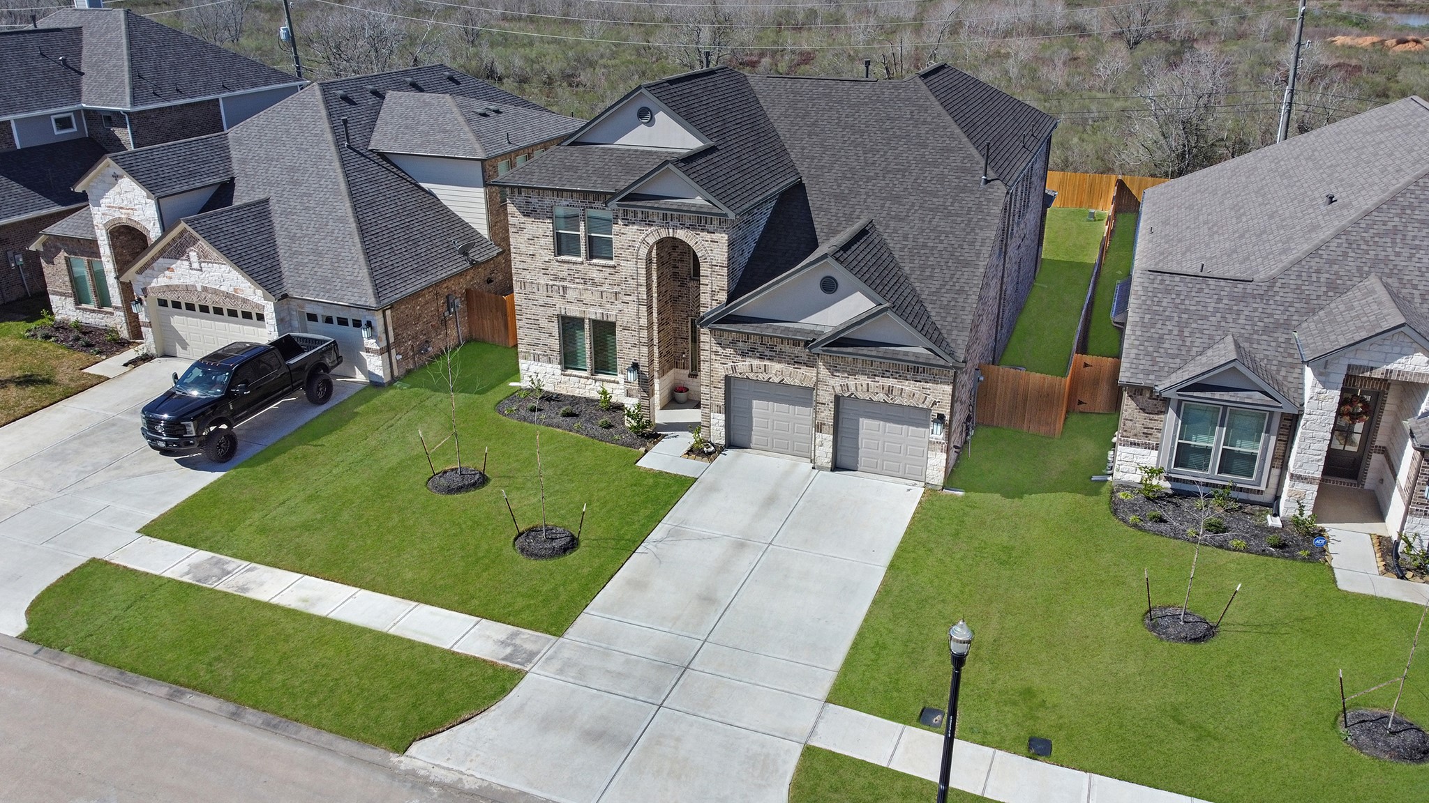 8 Palmero Way Manvel, TX 77578 - Photo 30 of 34 a view of a house with a backyard and a patio