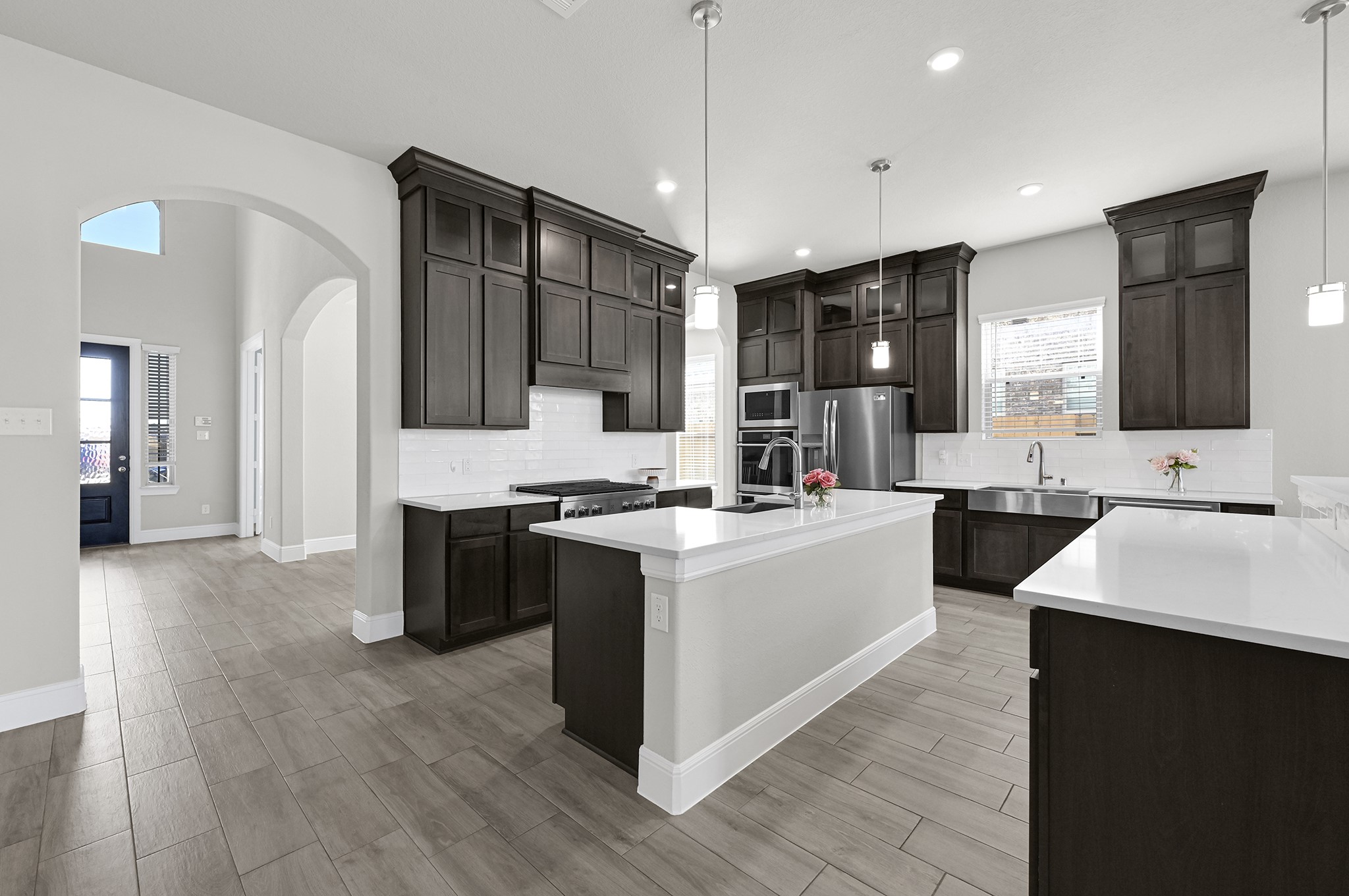 8 Palmero Way Manvel, TX 77578 - Photo 7 of 34 a large kitchen with stainless steel appliances kitchen island granite countertop a stove and a sink