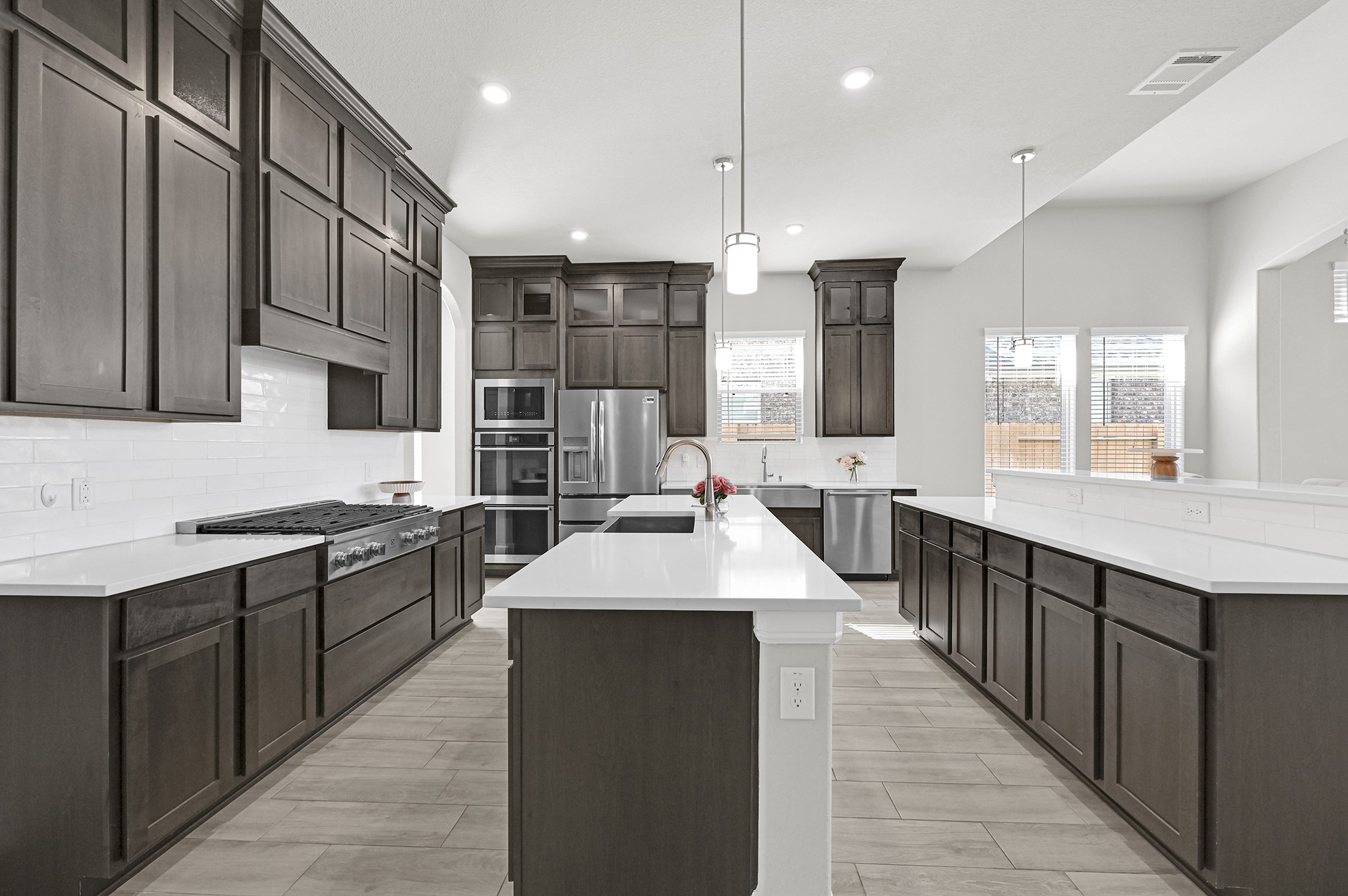 8 Palmero Way Manvel, TX 77578 - Photo 8 of 34 a large kitchen with stainless steel appliances kitchen island granite countertop a sink and a wooden floors