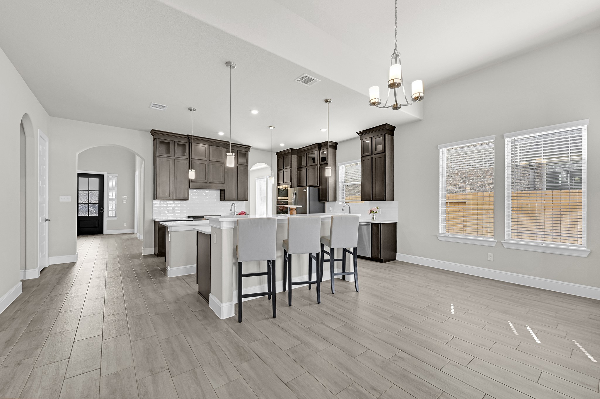 8 Palmero Way Manvel, TX 77578 - Photo 10 of 34 a open kitchen with stainless steel appliances refrigerator dining table and chairs