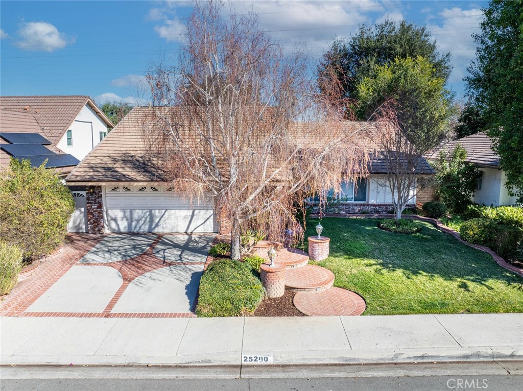25200 Ave Rotella Valencia, CA 91355 - Photo 1 of 24 a front view of a house with a yard