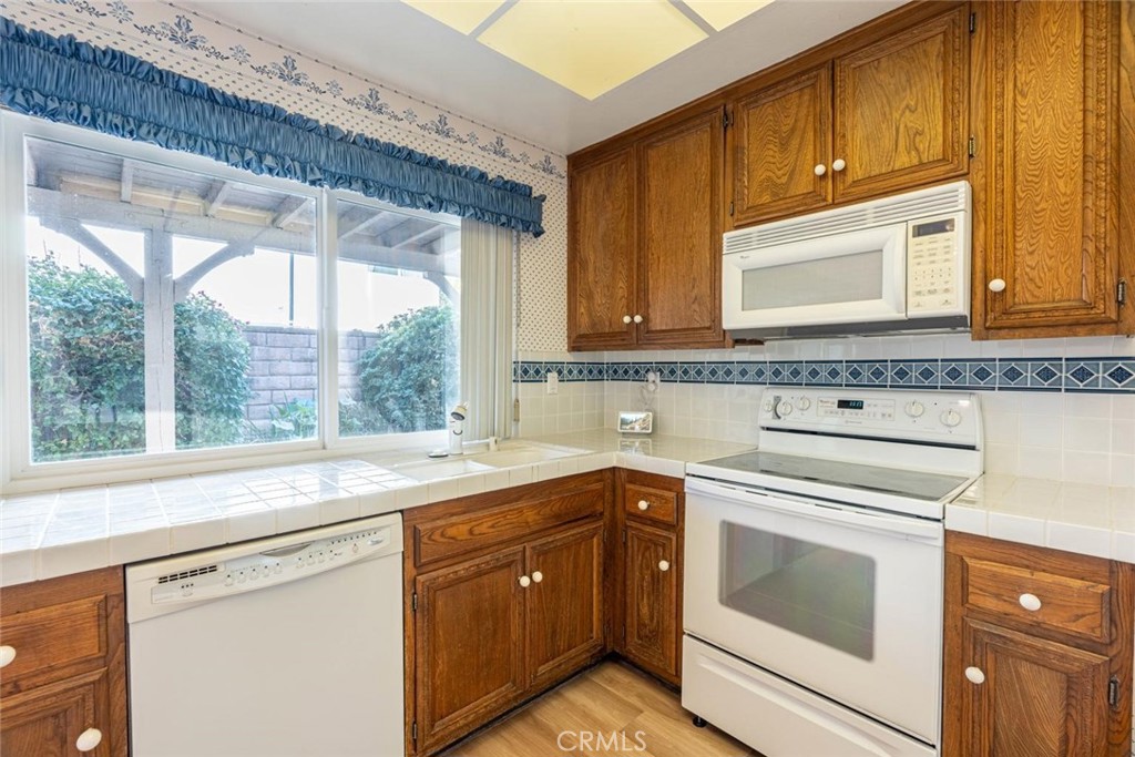 25200 Ave Rotella Valencia, CA 91355 - Photo 7 of 24 a kitchen with a sink stove and cabinets