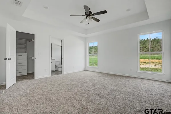 a view of a livingroom with a window and a ceiling fan