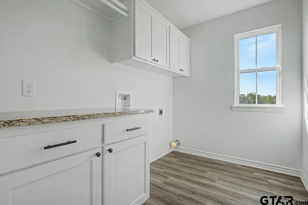 a view of storage and utility room with wooden floor
