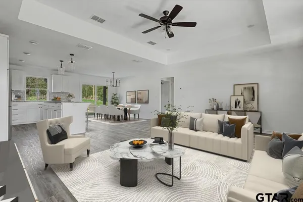 a living room with furniture and kitchen view