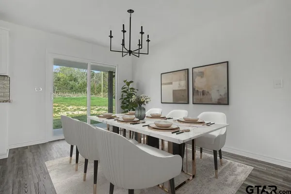 a dining room with furniture a chandelier and wooden floor