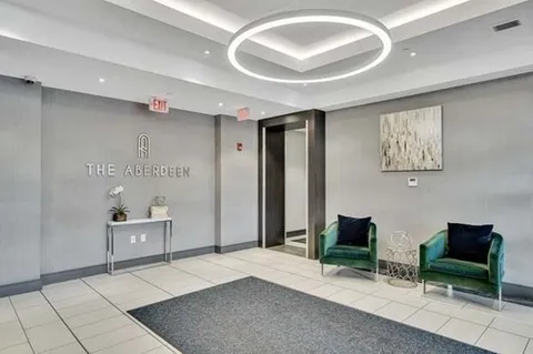 a bedroom with furniture and a large mirror