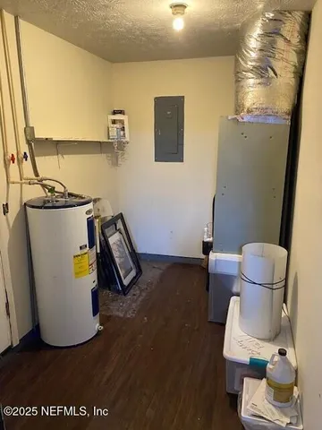 a water heater room with wooden floor