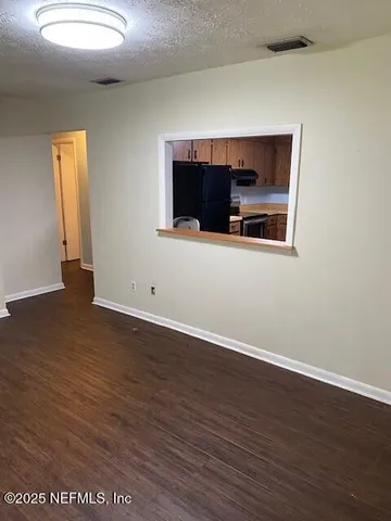a view of a room with wooden floor