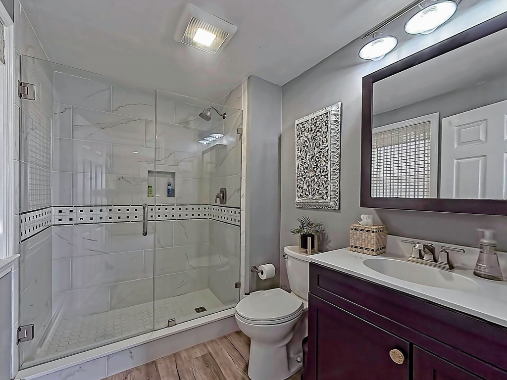 35 Prospect Avenue Hull, MA 02045 - Photo 31 of 42 a bathroom with a shower sink vanity mirror and toilet