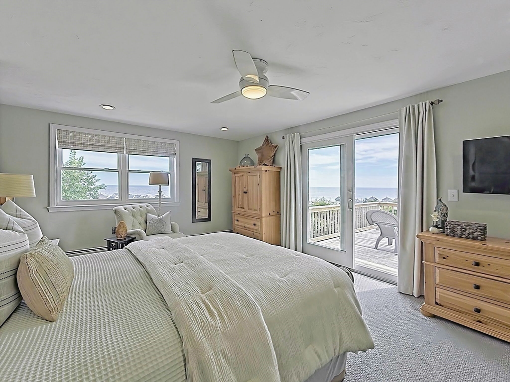 35 Prospect Avenue Hull, MA 02045 - Photo 32 of 42 a bedroom with a large bed and a tv on dresser