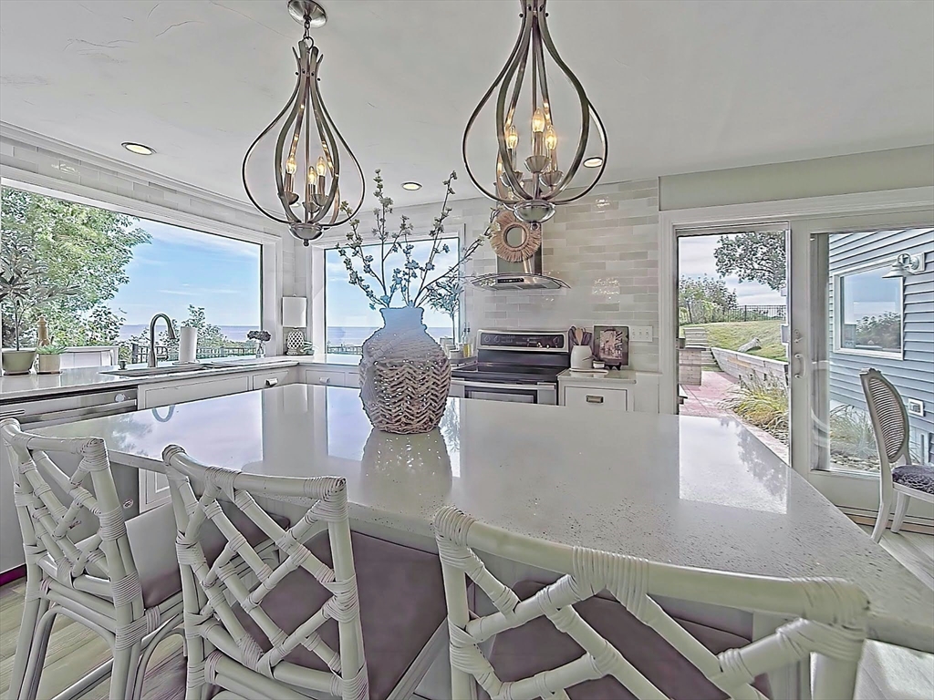 35 Prospect Avenue Hull, MA 02045 - Photo 7 of 42 a view of a dining room with furniture wooden floor and chandelier