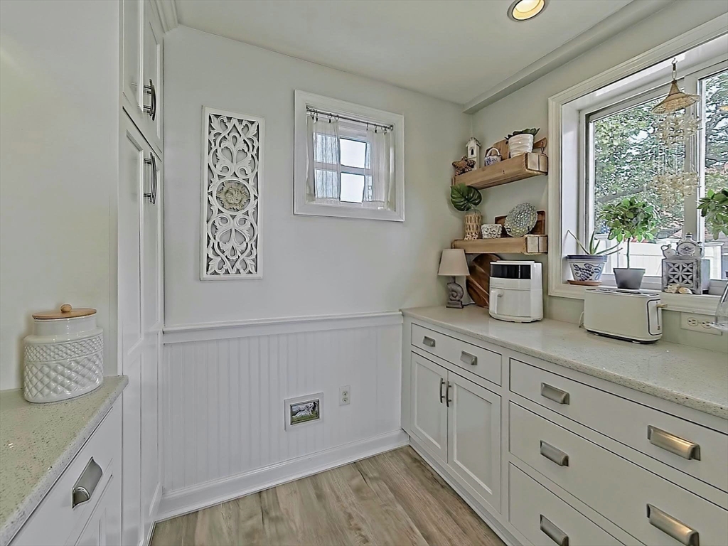 35 Prospect Avenue Hull, MA 02045 - Photo 9 of 42 a view of cabinets a window and a wooden floor