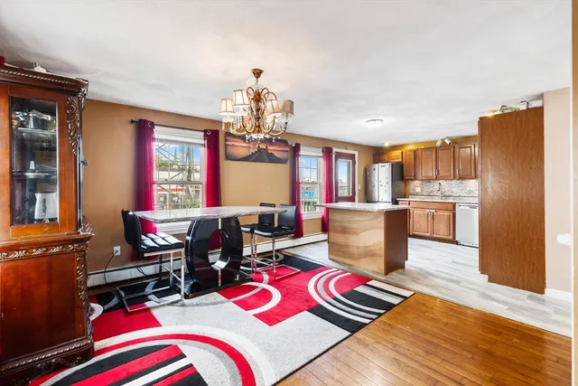 a living room with furniture and a dining table