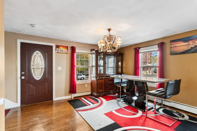 a view of a dining hall with furniture chandelier and wooden floor
