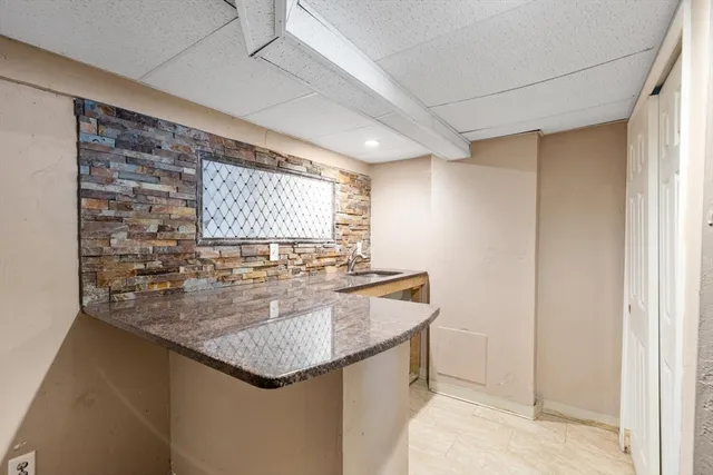 a view of an empty room with wooden floor and a flat screen tv