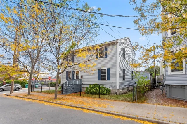 a view of a house with a yard and tree s