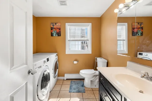 a bathroom with a sink toilet and a mirror