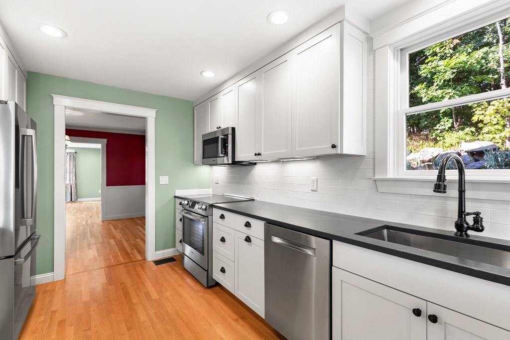8 Doctors Run Rockport, MA 01966 - Photo 16 of 38 a kitchen with stainless steel appliances granite countertop a sink and a stove