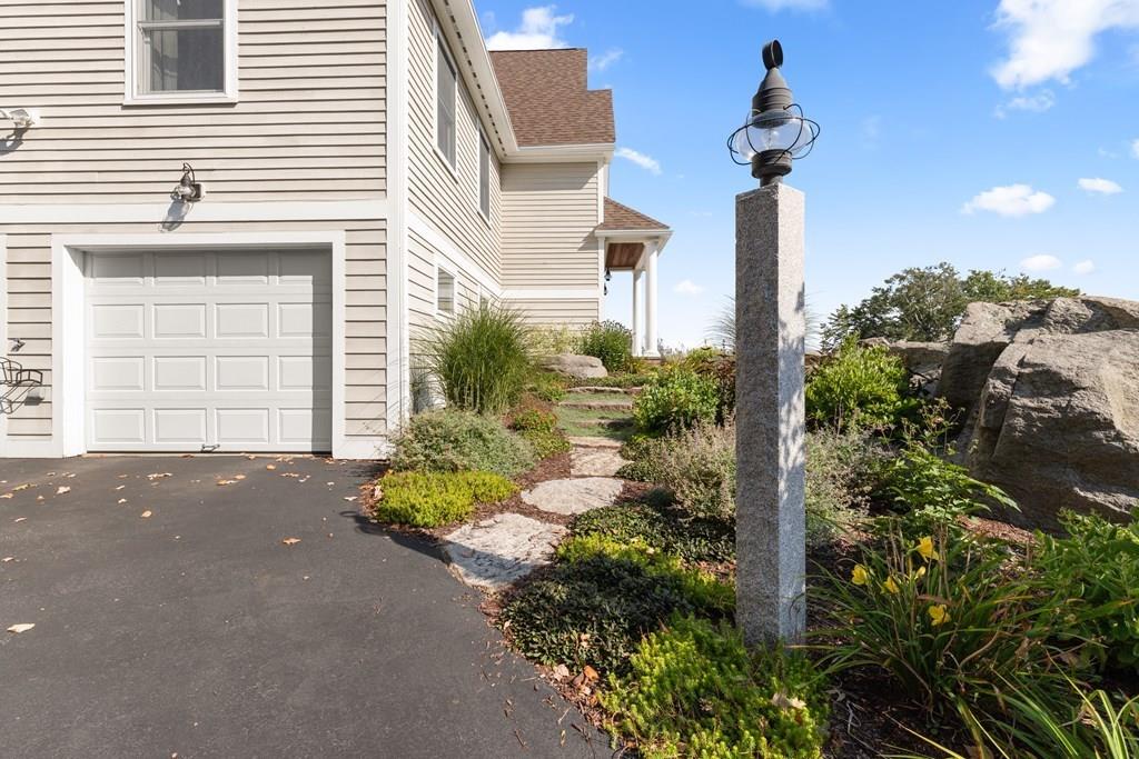 8 Doctors Run Rockport, MA 01966 - Photo 3 of 38 a front view of a house with a yard and garage