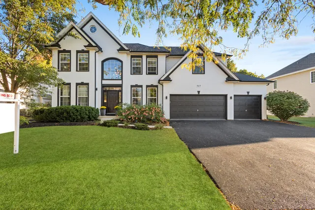 a front view of a house with a yard and garage